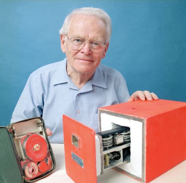 David Warren holding his black box flight data recorder prototype.